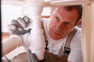 a Stonegate plumber inspects the drain system